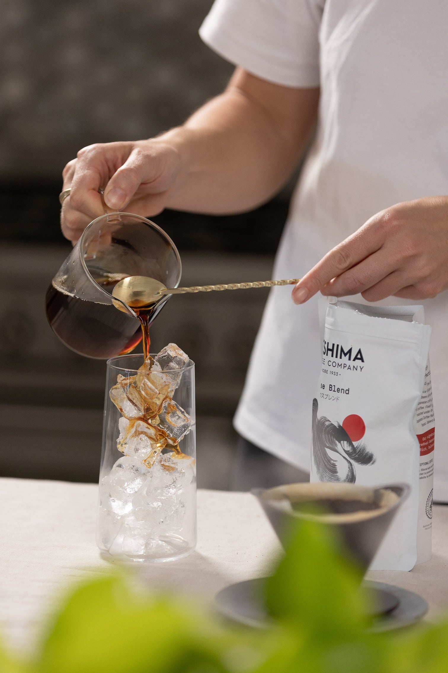 Pouring coffee into a cup to make a japanese iced coffee